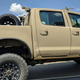 Illustration for article titled Check Out This Militarized Toyota Hilux and Its Weird Door Handles